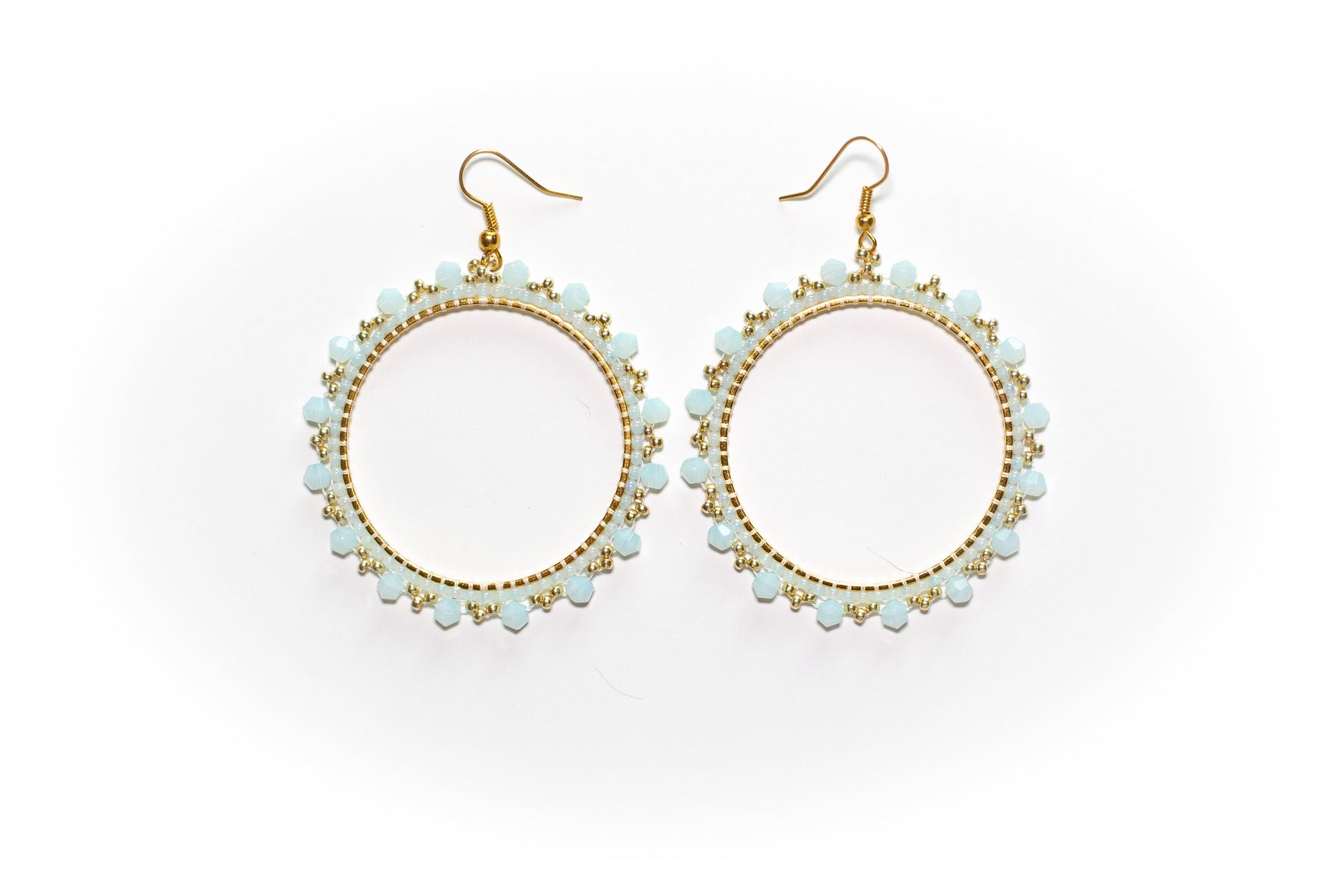 a pair of earrings on a white background