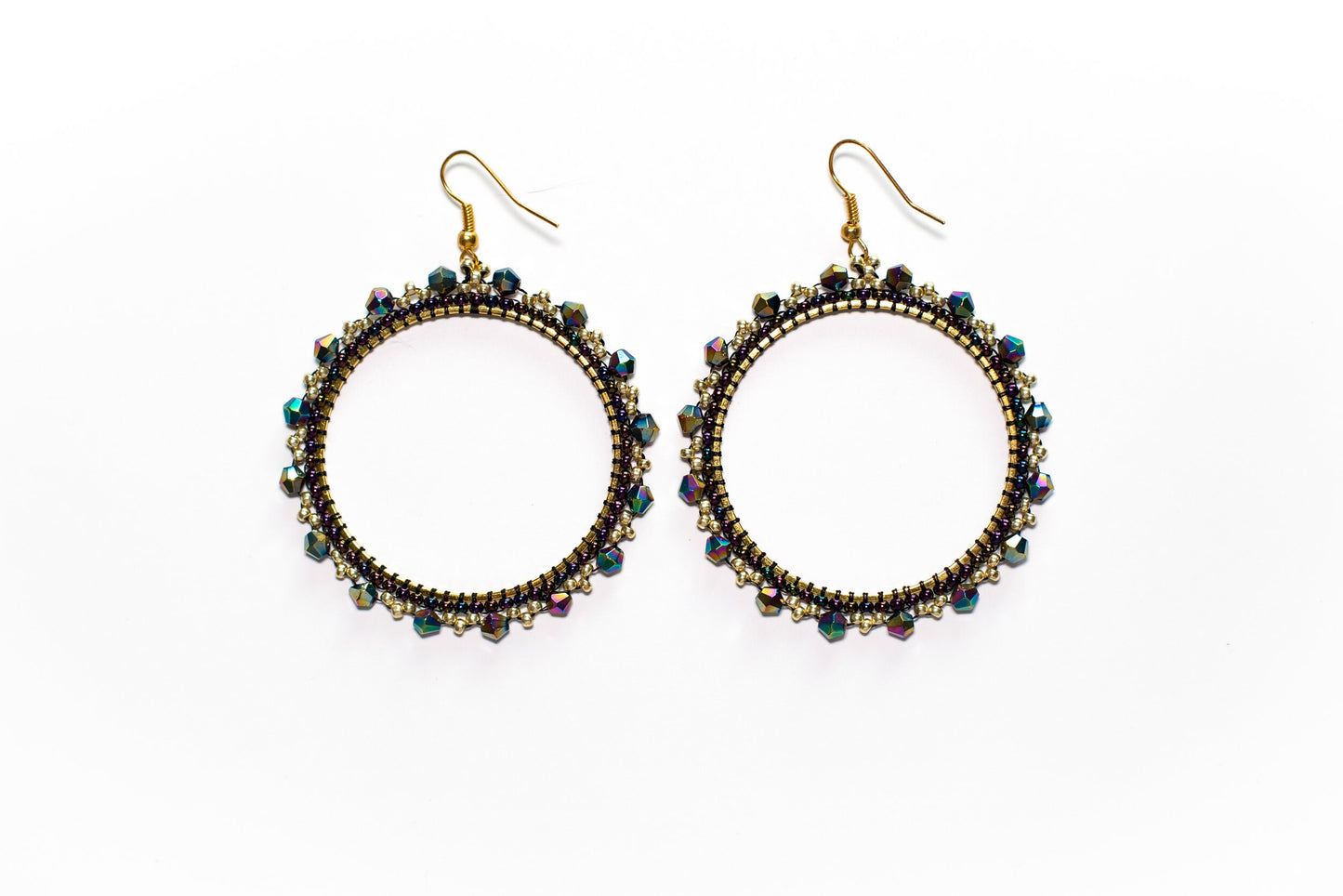 a pair of earrings with beads on a white background