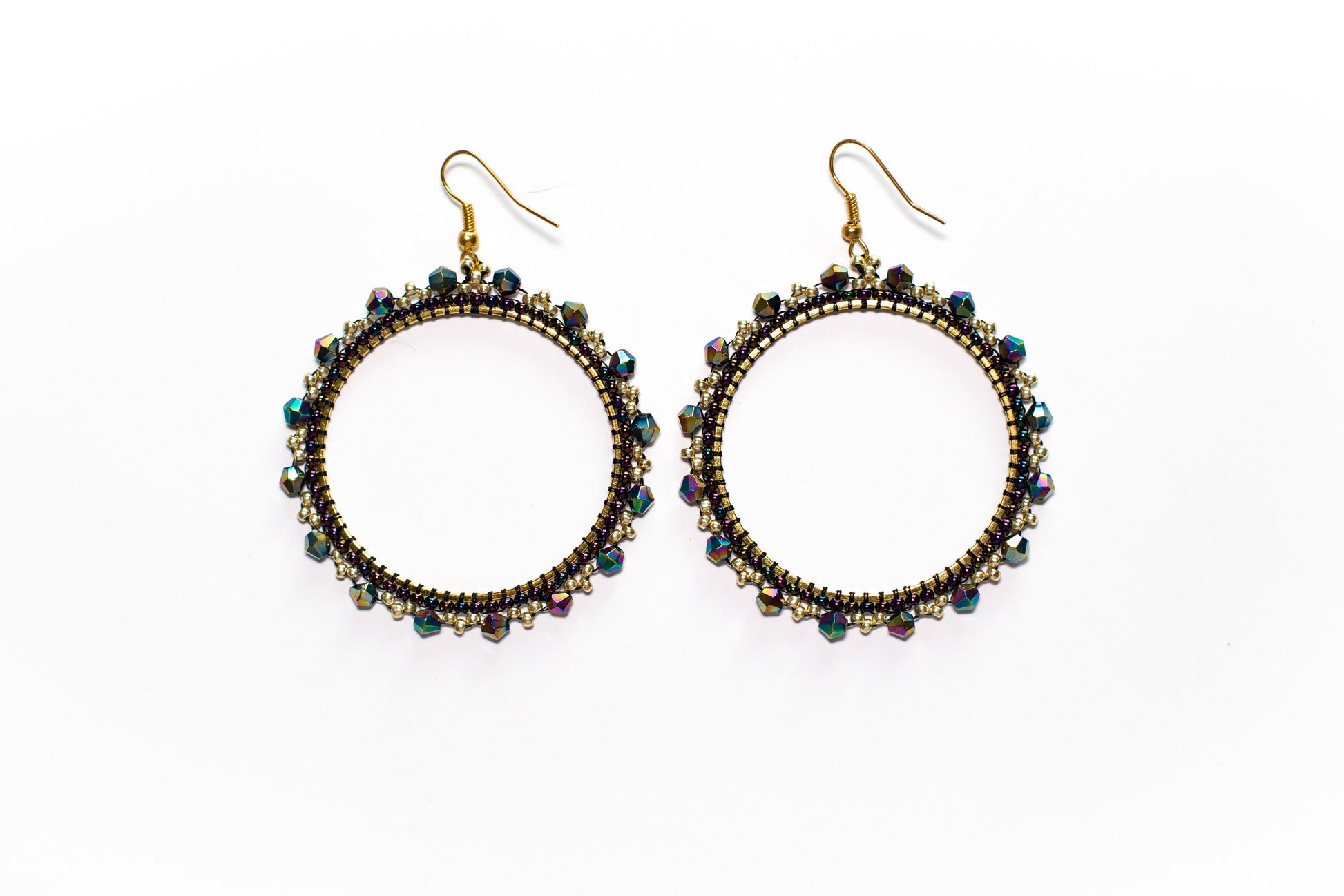 a pair of earrings with beads on a white background