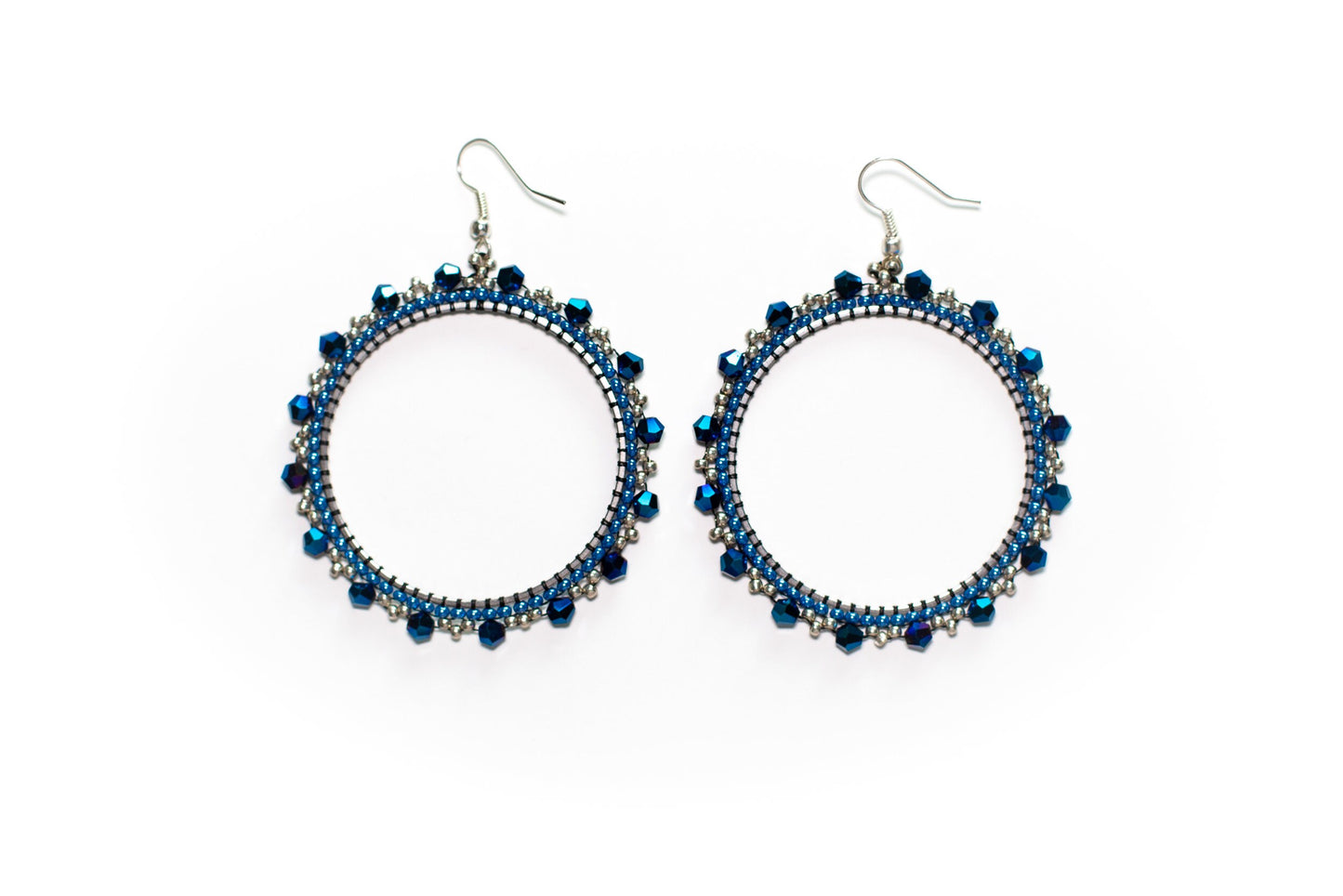 a pair of black beaded earrings on a white background