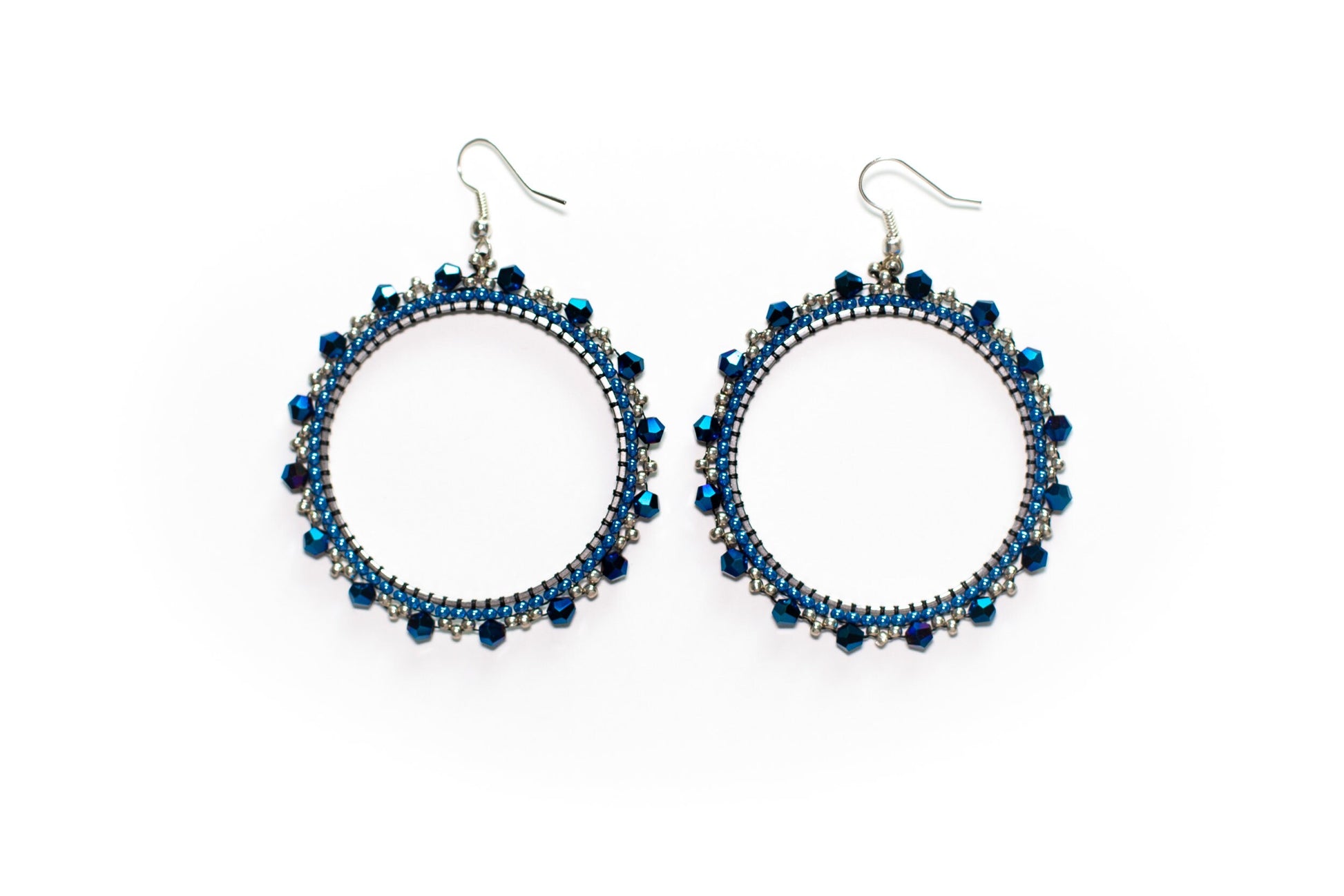 a pair of black beaded earrings on a white background