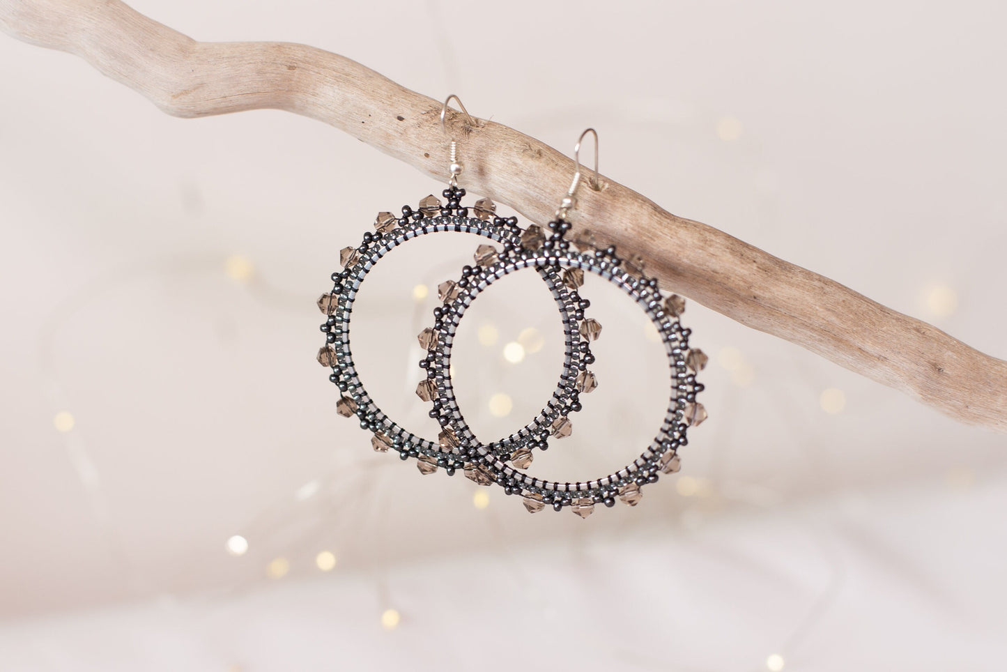 a pair of earrings hanging from a tree branch