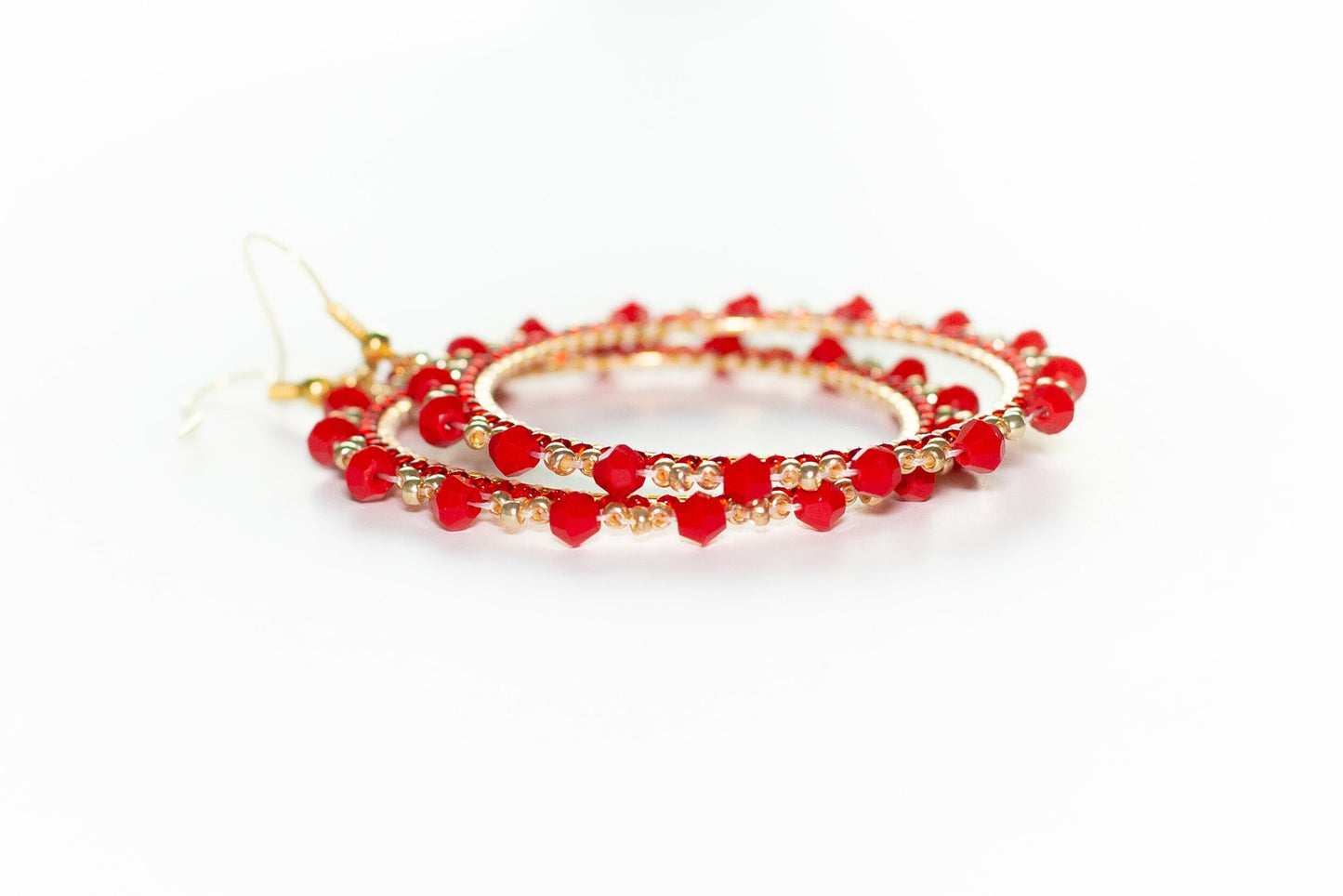 a pair of red beaded bracelets on a white background