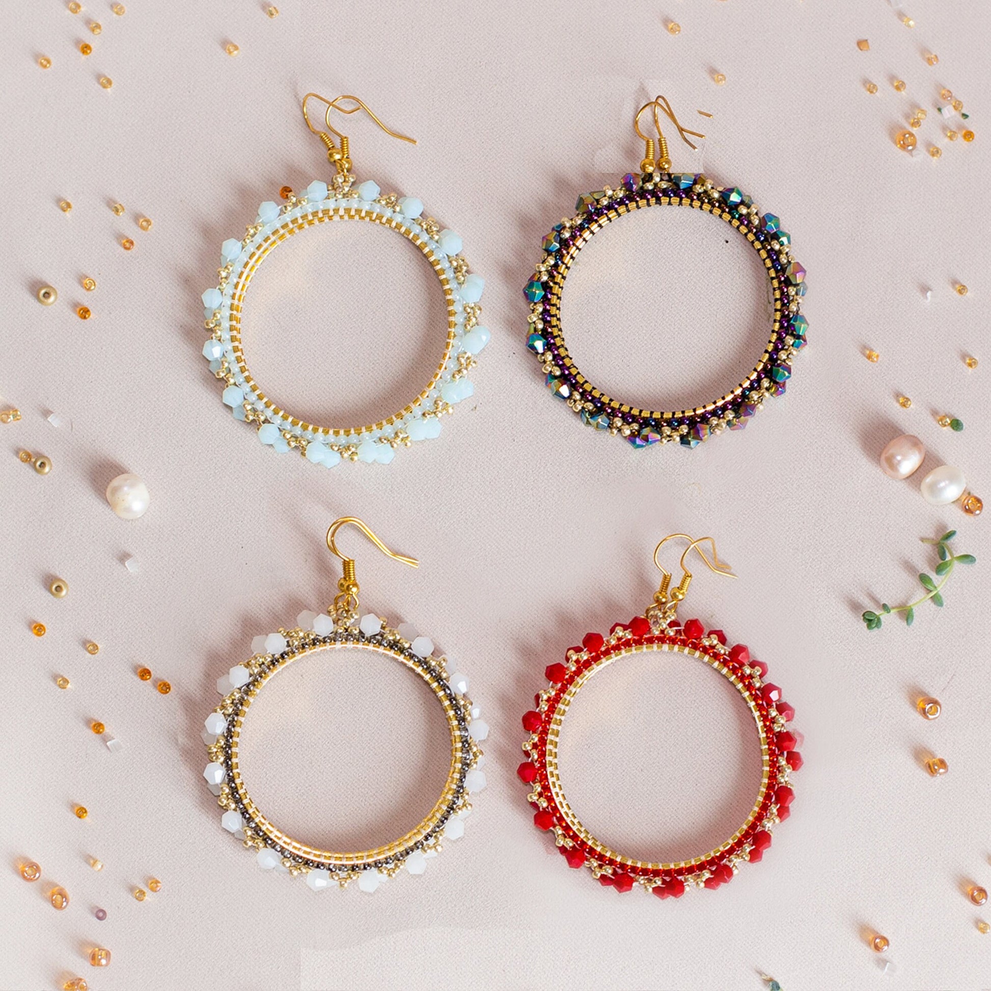 a pair of earrings on a white background