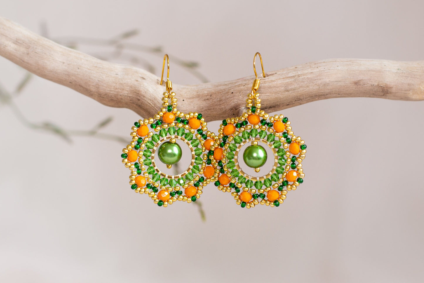 a pair of green and orange beaded earrings