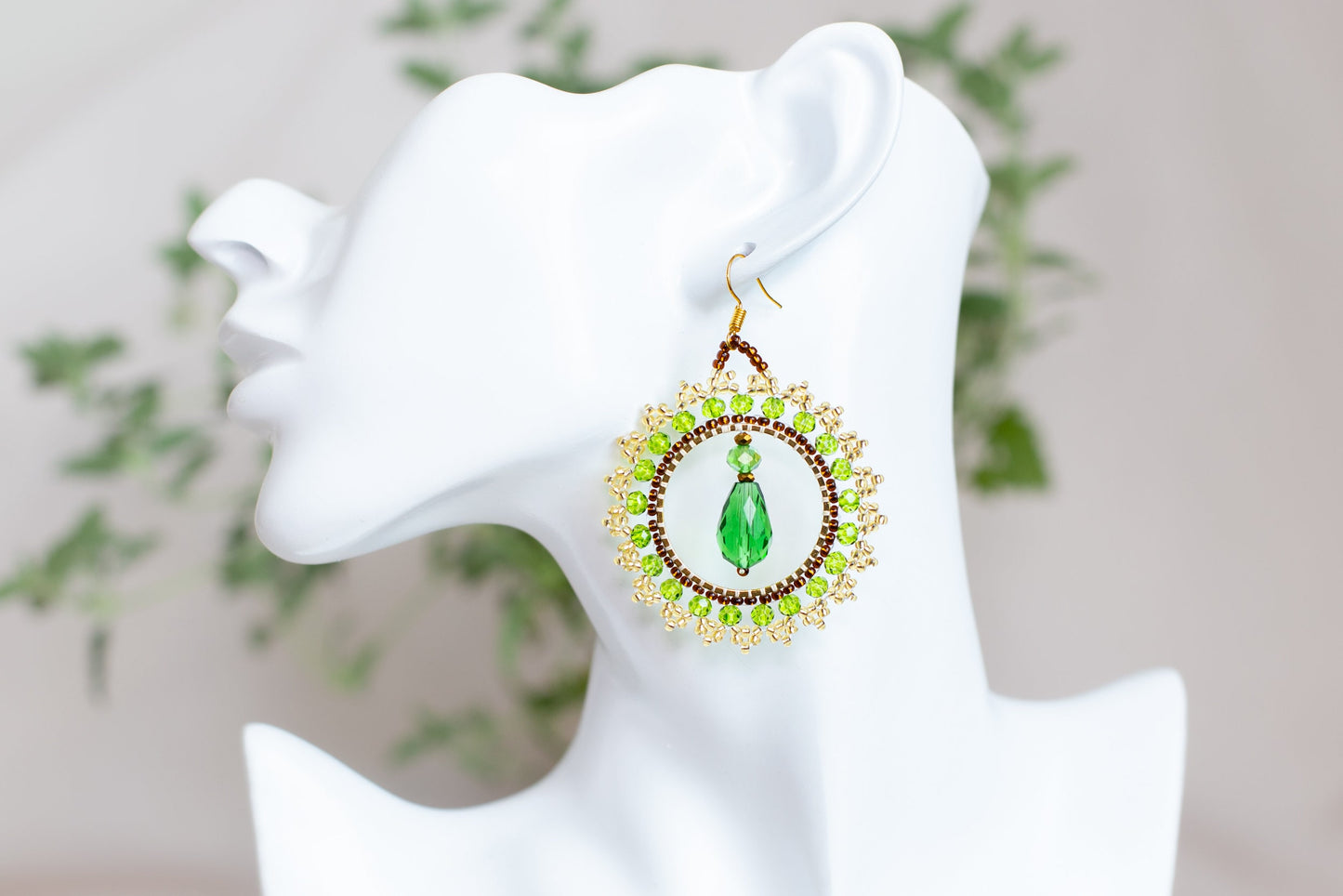 a close up of a pair of earrings on a mannequin head