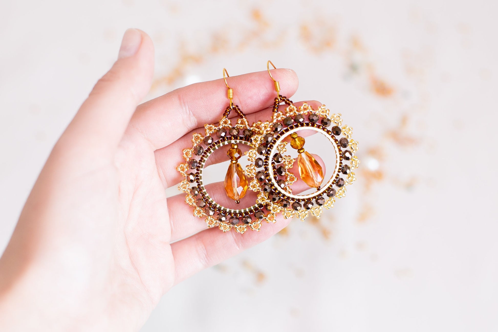 a person holding a pair of earrings in their hand