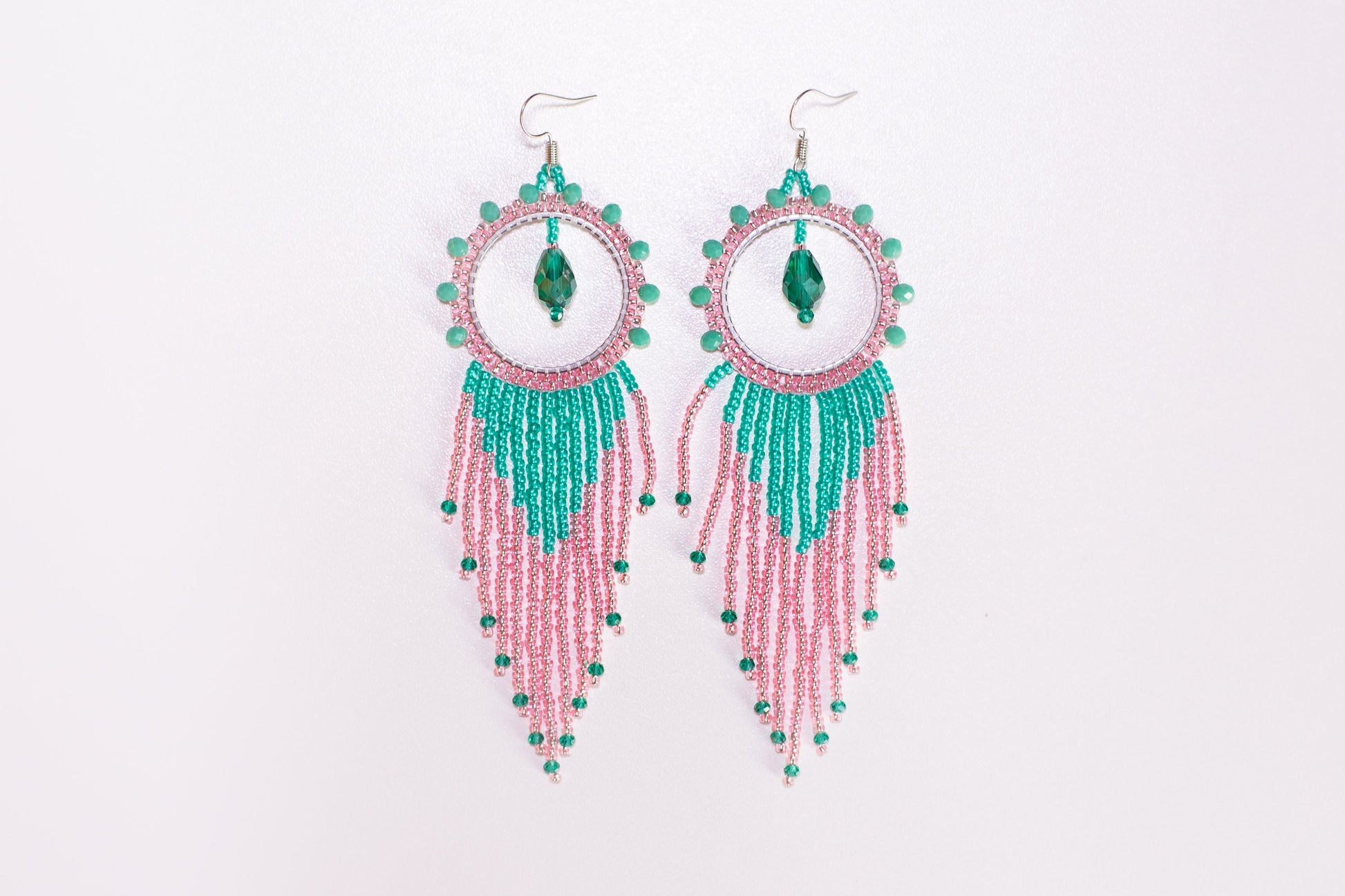 a person holding a pair of earrings in their hand