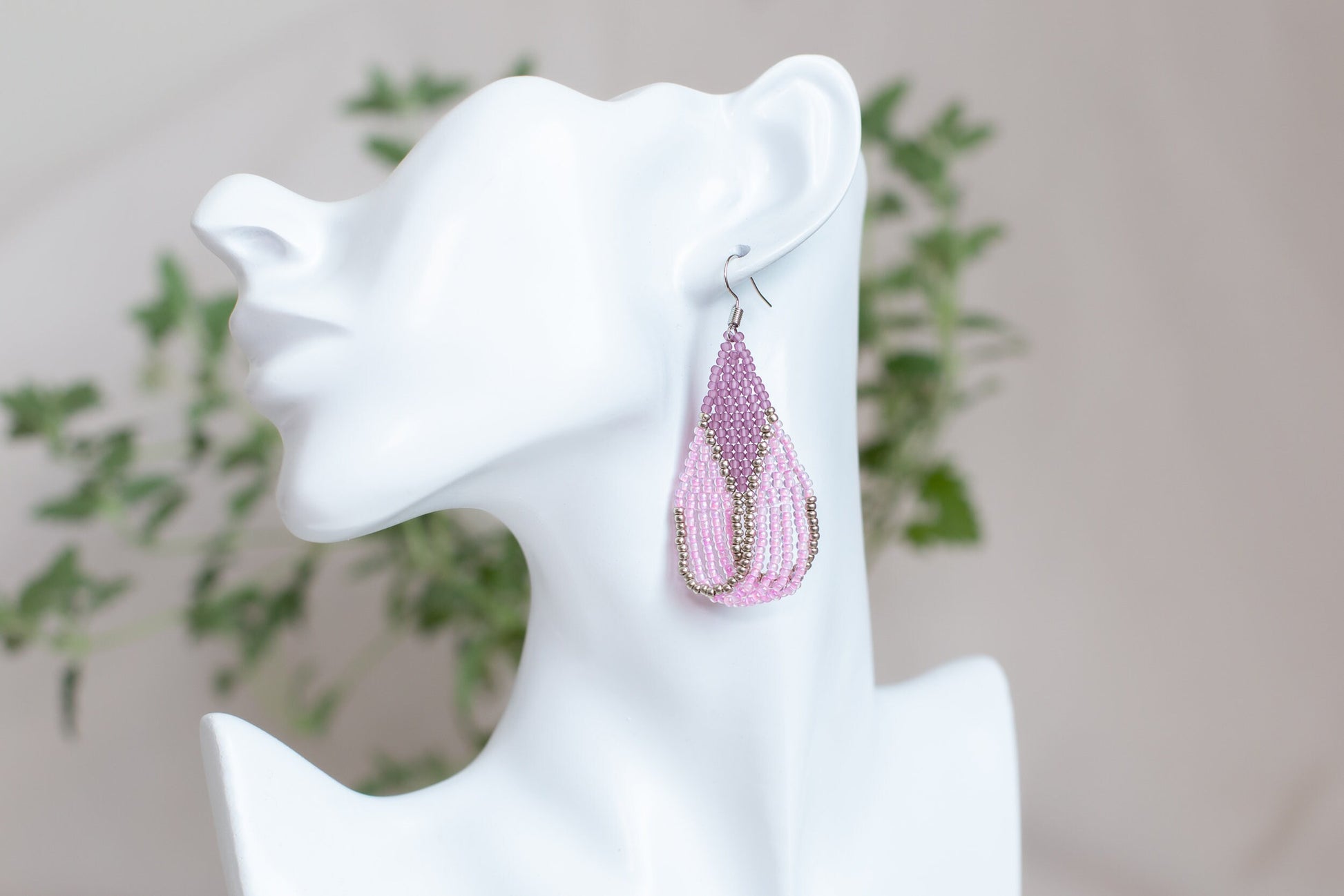 a close up of a pair of earrings on a mannequin head