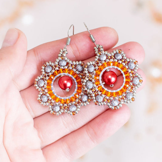 a pair of earrings on a white surface