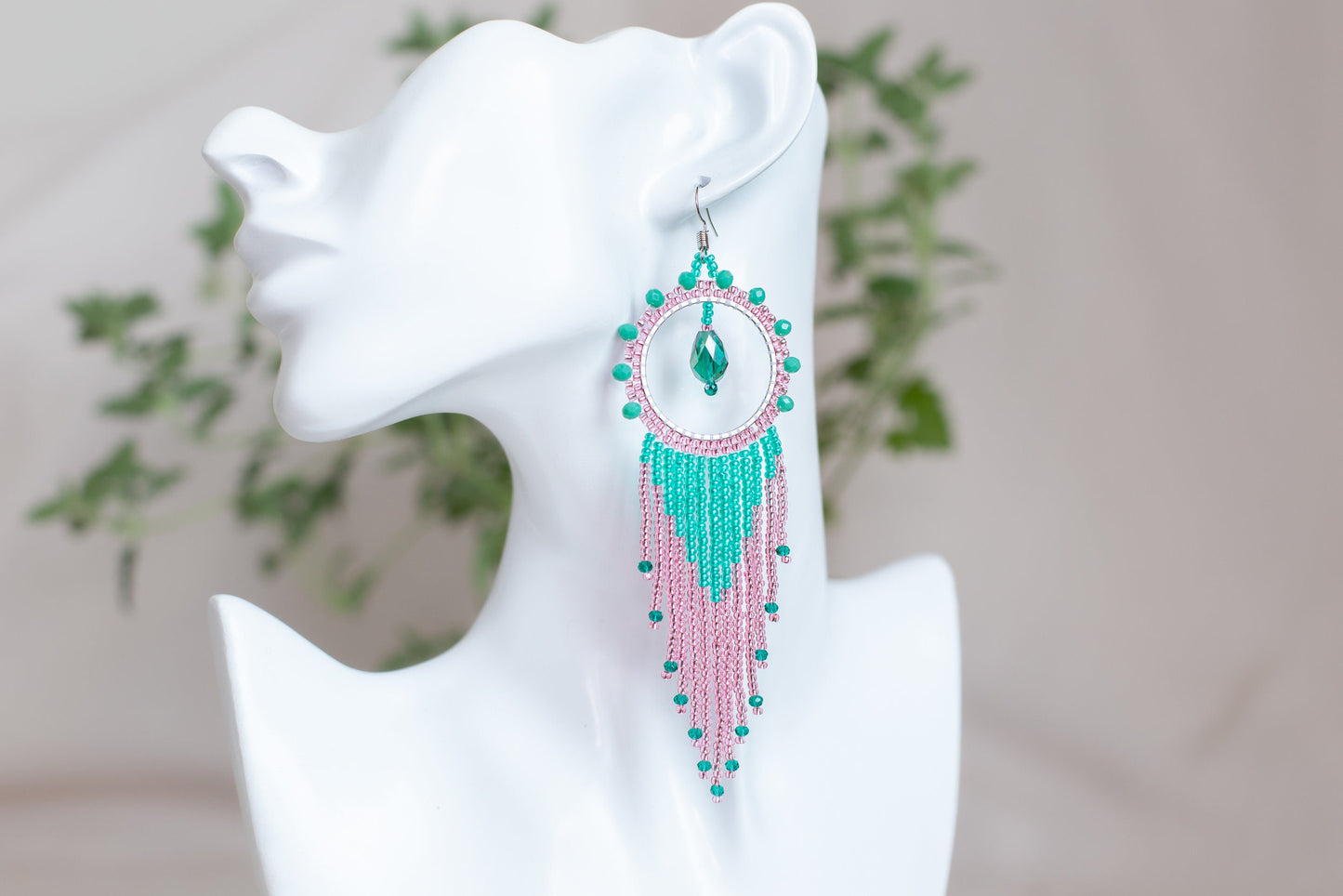 a close up of a pair of earrings on a mannequin head