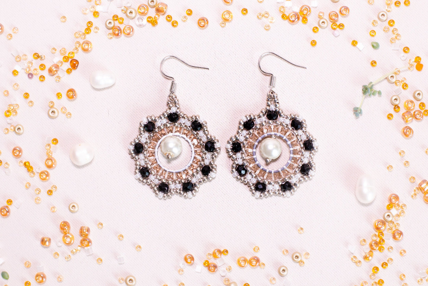 a pair of earrings sitting on top of a table