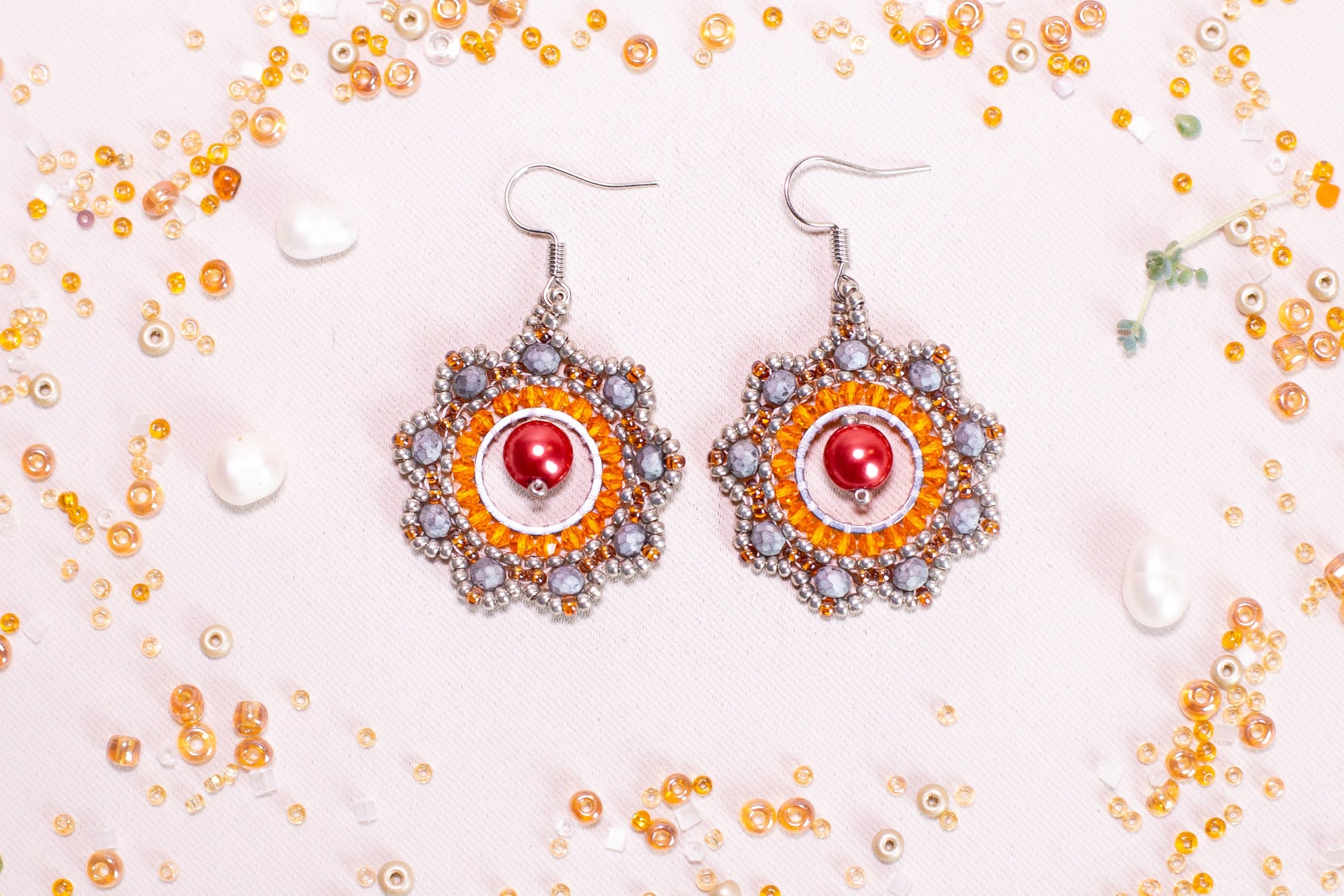 a pair of earrings on a white surface