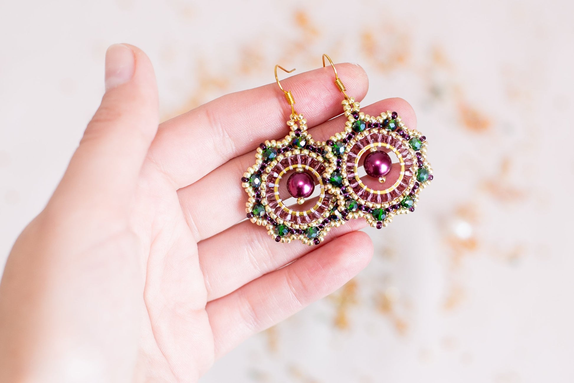 a person holding a pair of earrings in their hand