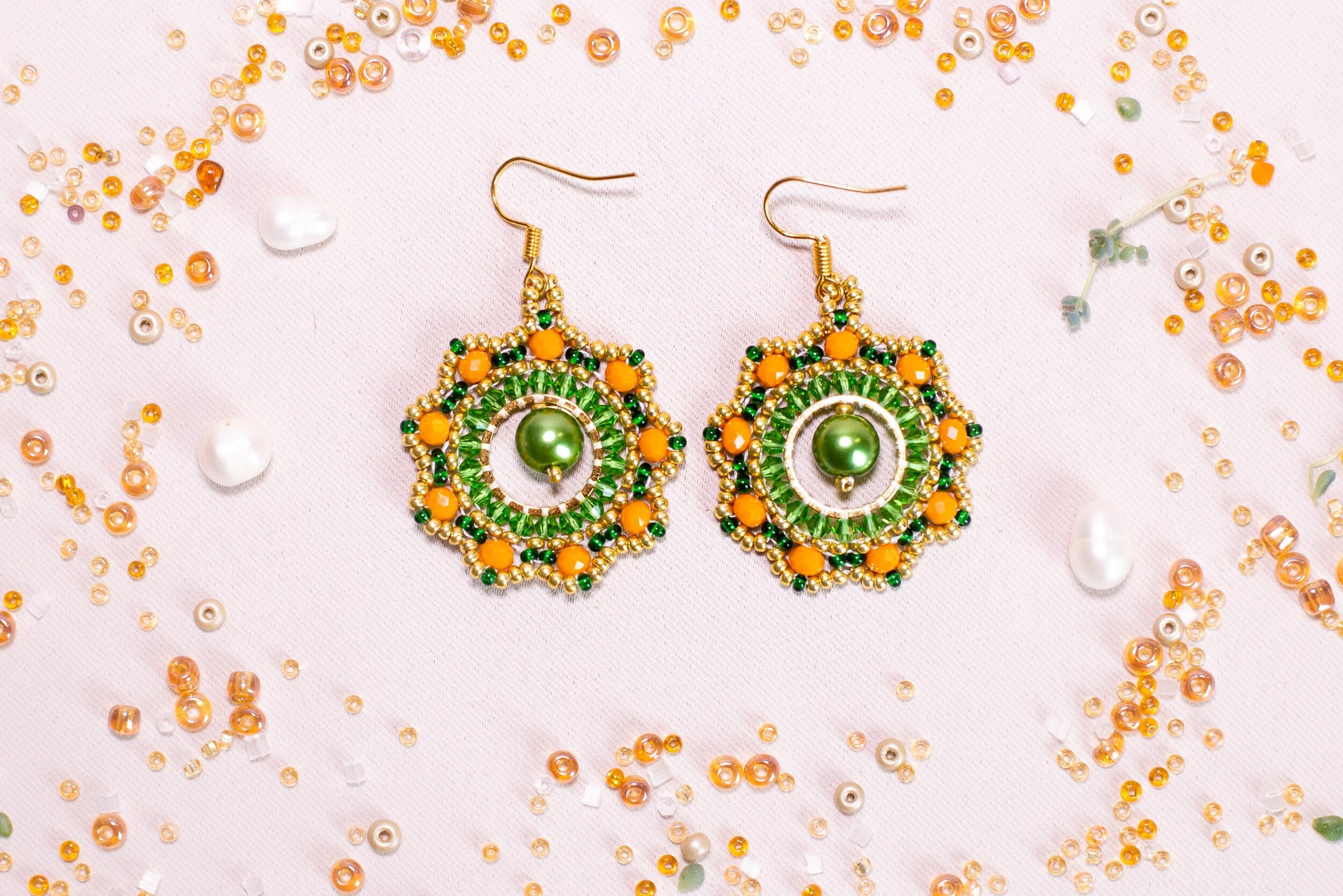 a pair of green and yellow beaded earrings