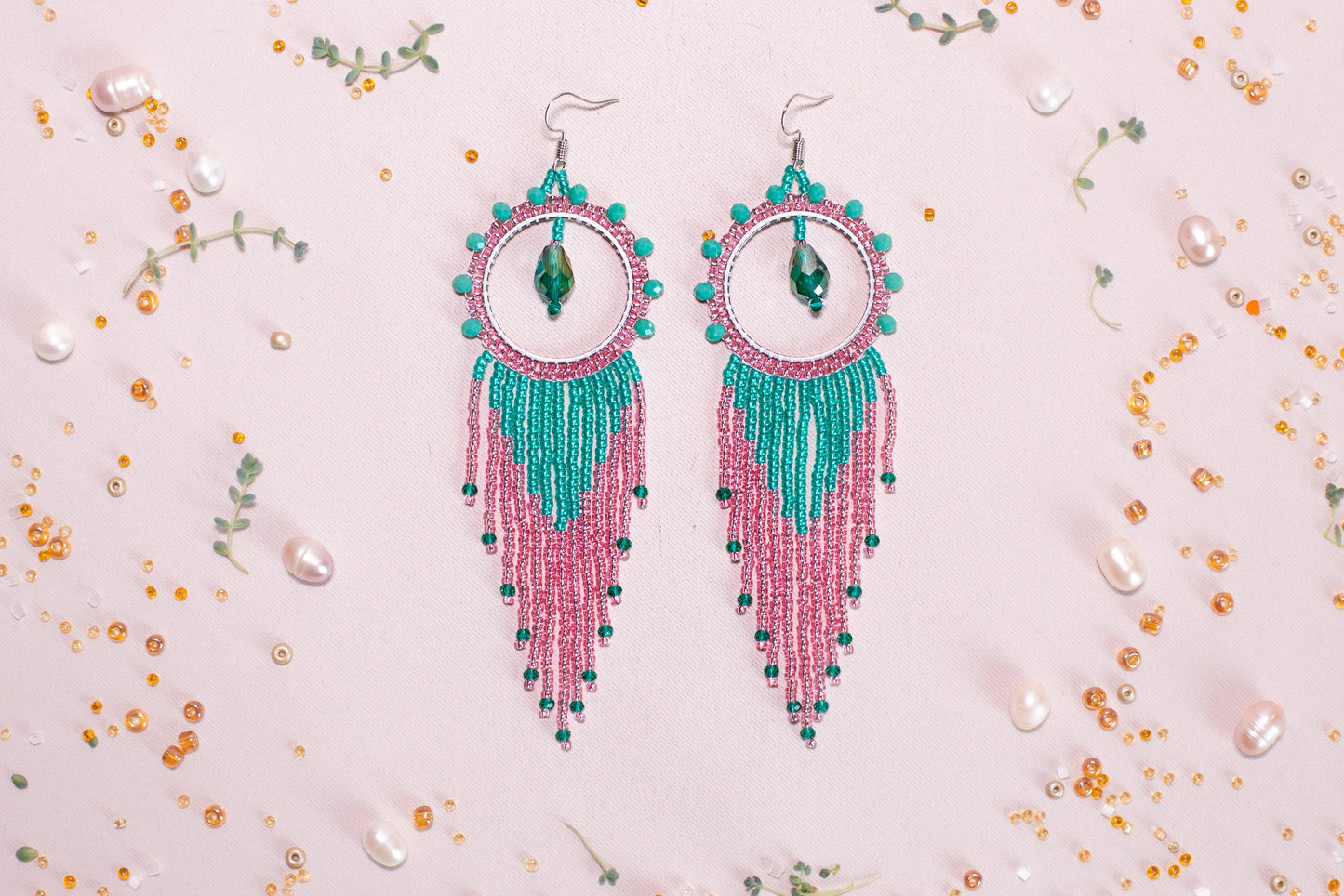 a pair of pink and green beaded earrings