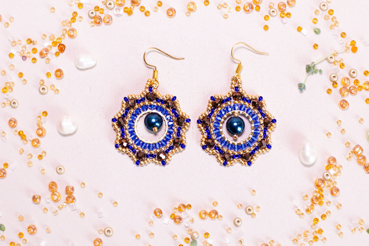 a pair of blue and gold beaded earrings