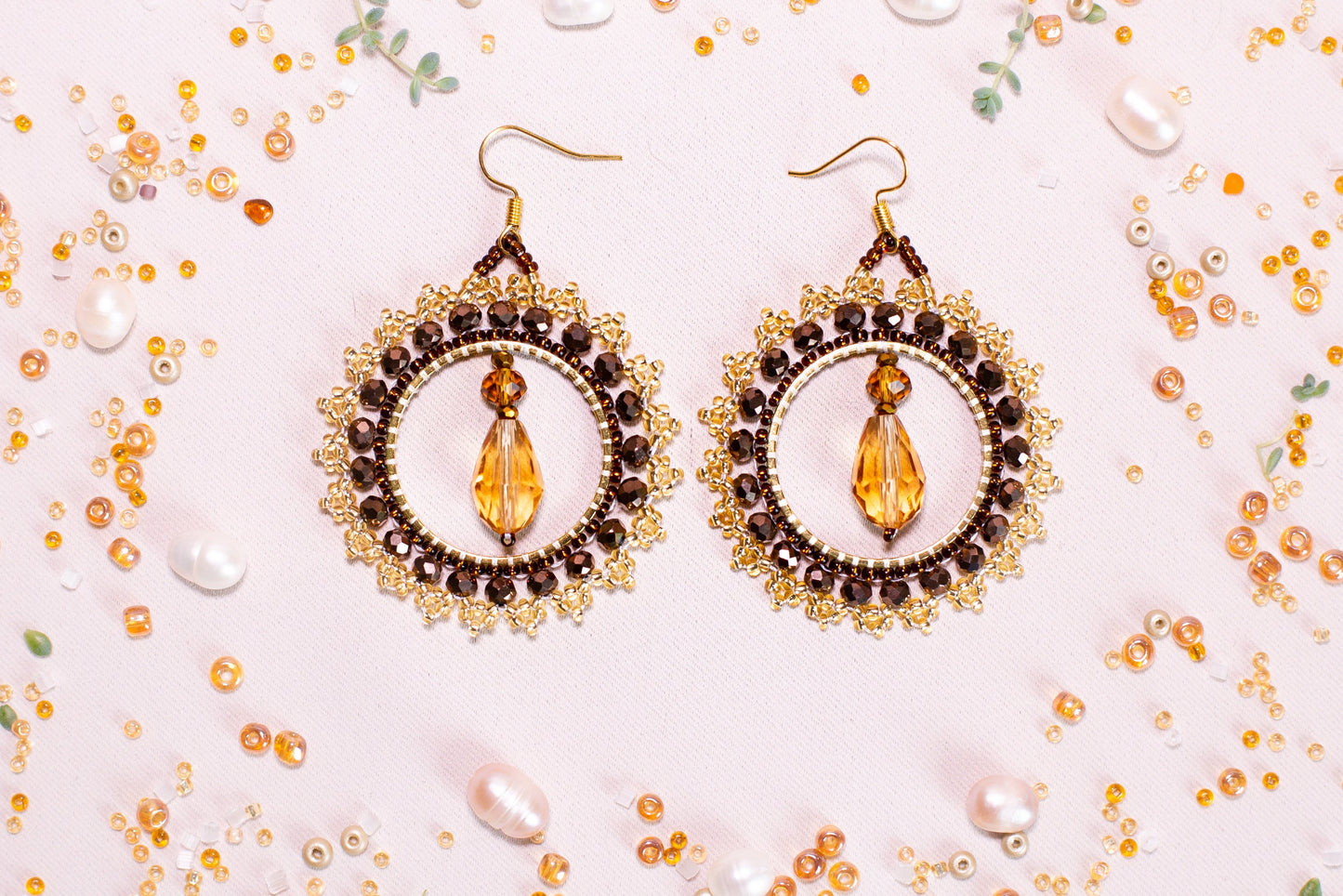 a pair of earrings on a white surface