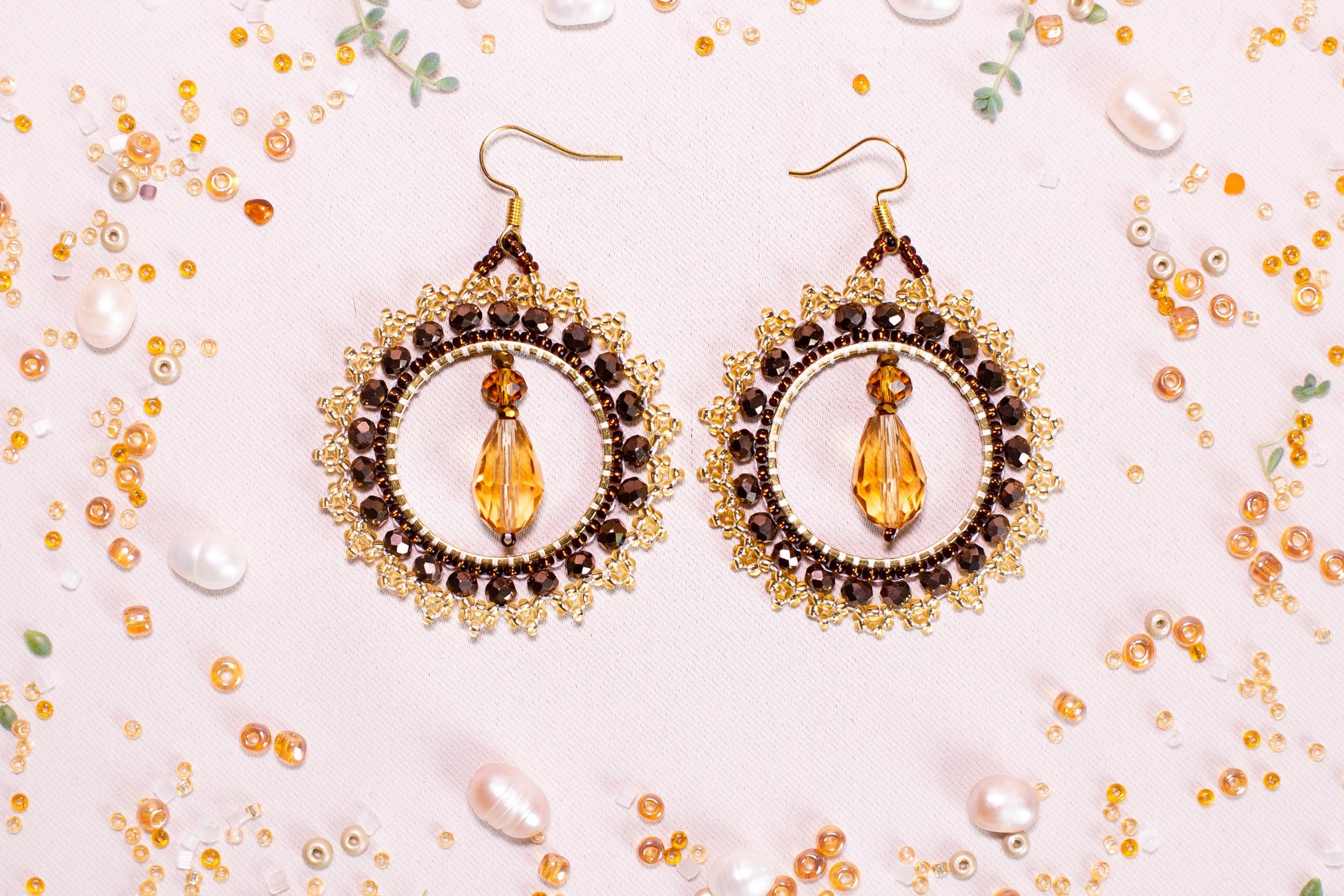 a pair of earrings on a white surface