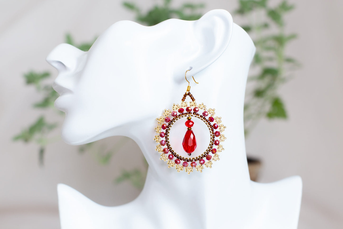 a close up of a pair of earrings on a mannequin head