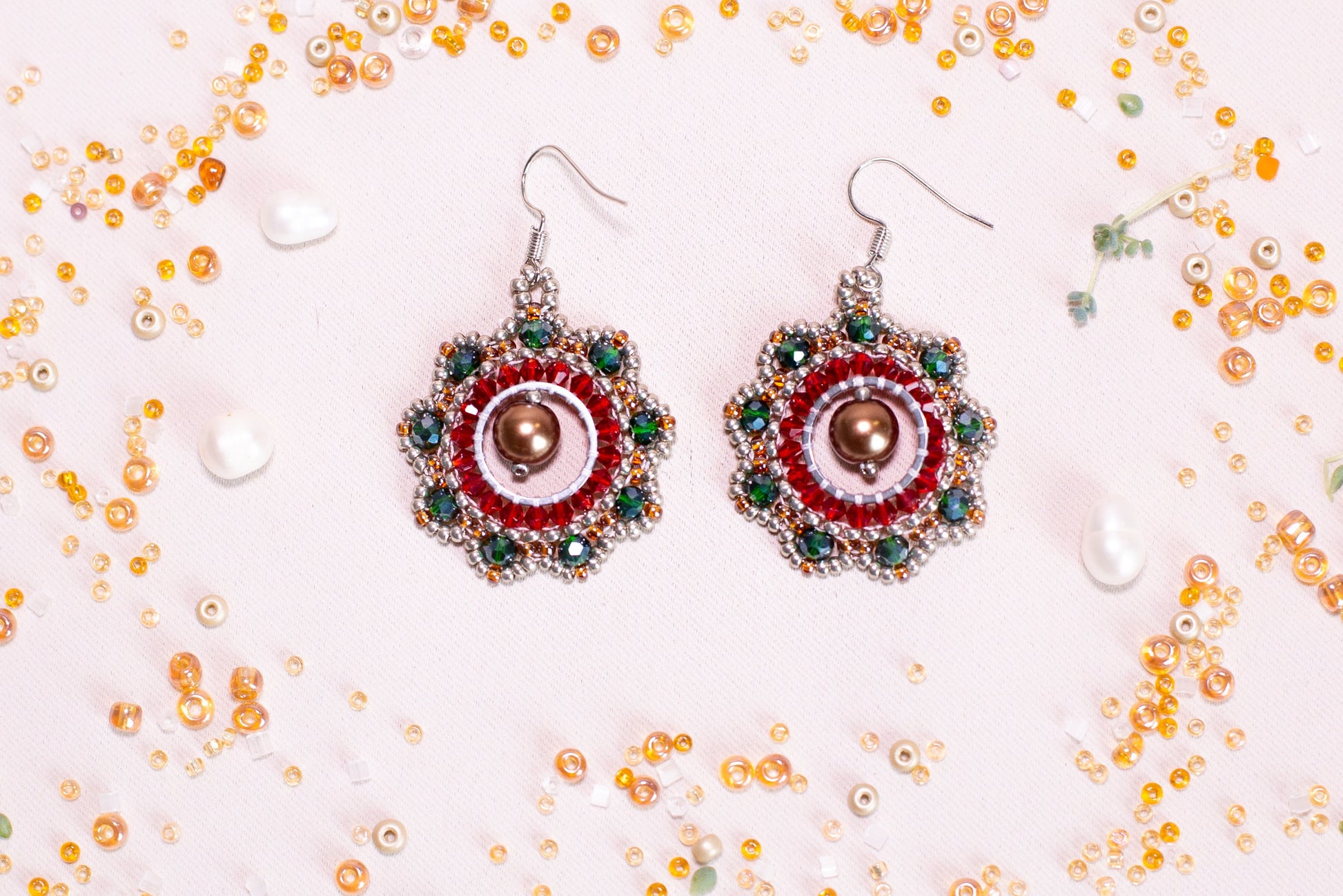 a pair of red and green beaded earrings
