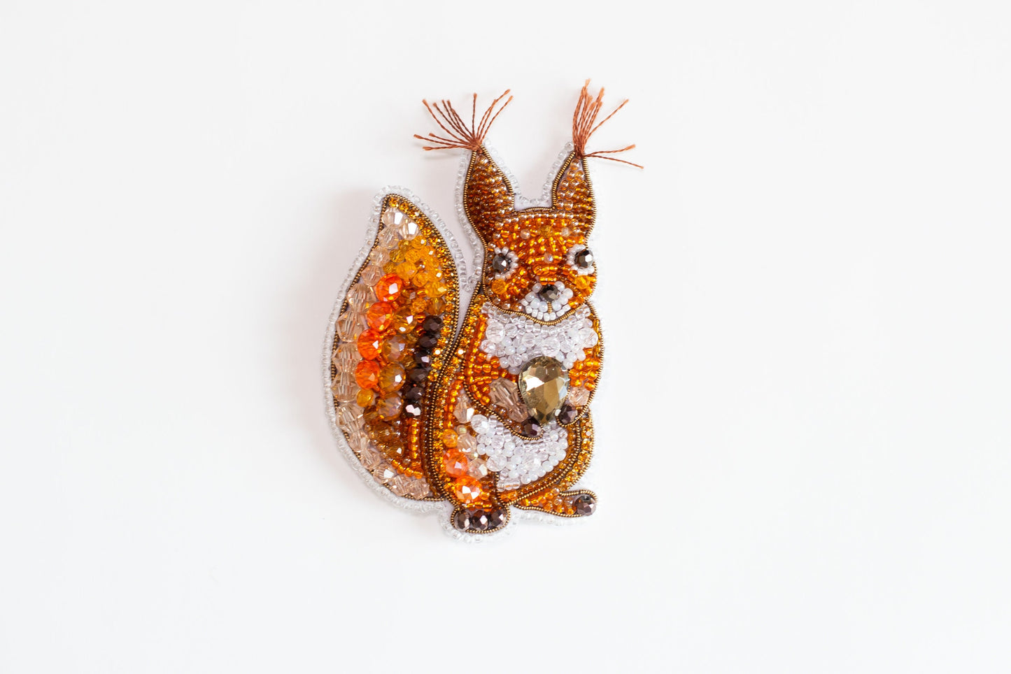a brooch with a squirrel on it's back