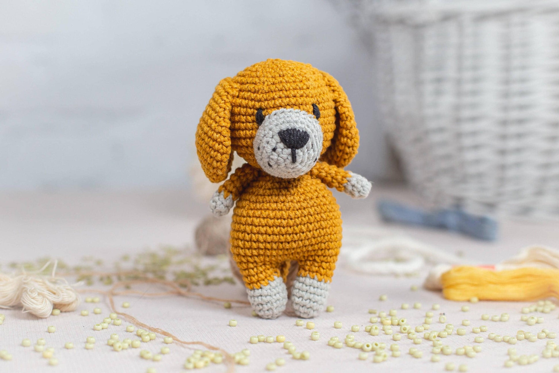 a crocheted dog is standing on a table