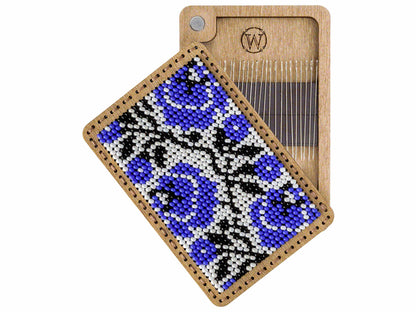 a wooden comb with a blue and black design on it