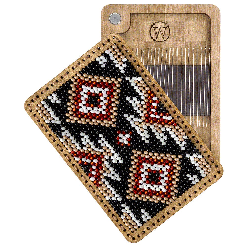 a wooden comb with a beaded design on it