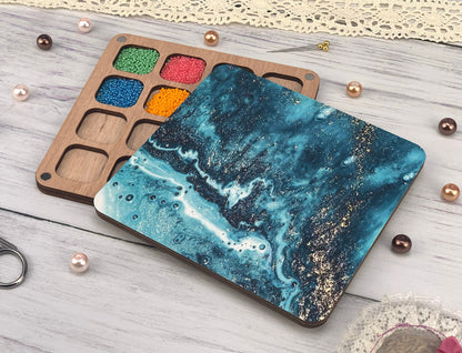 a wooden tray with paint and a pair of scissors