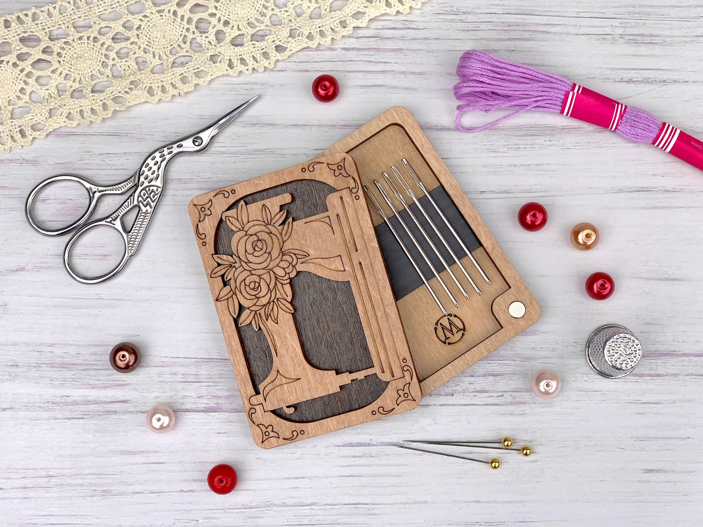 a pair of scissors, a pair of knitting needles, a pair of knitting needles