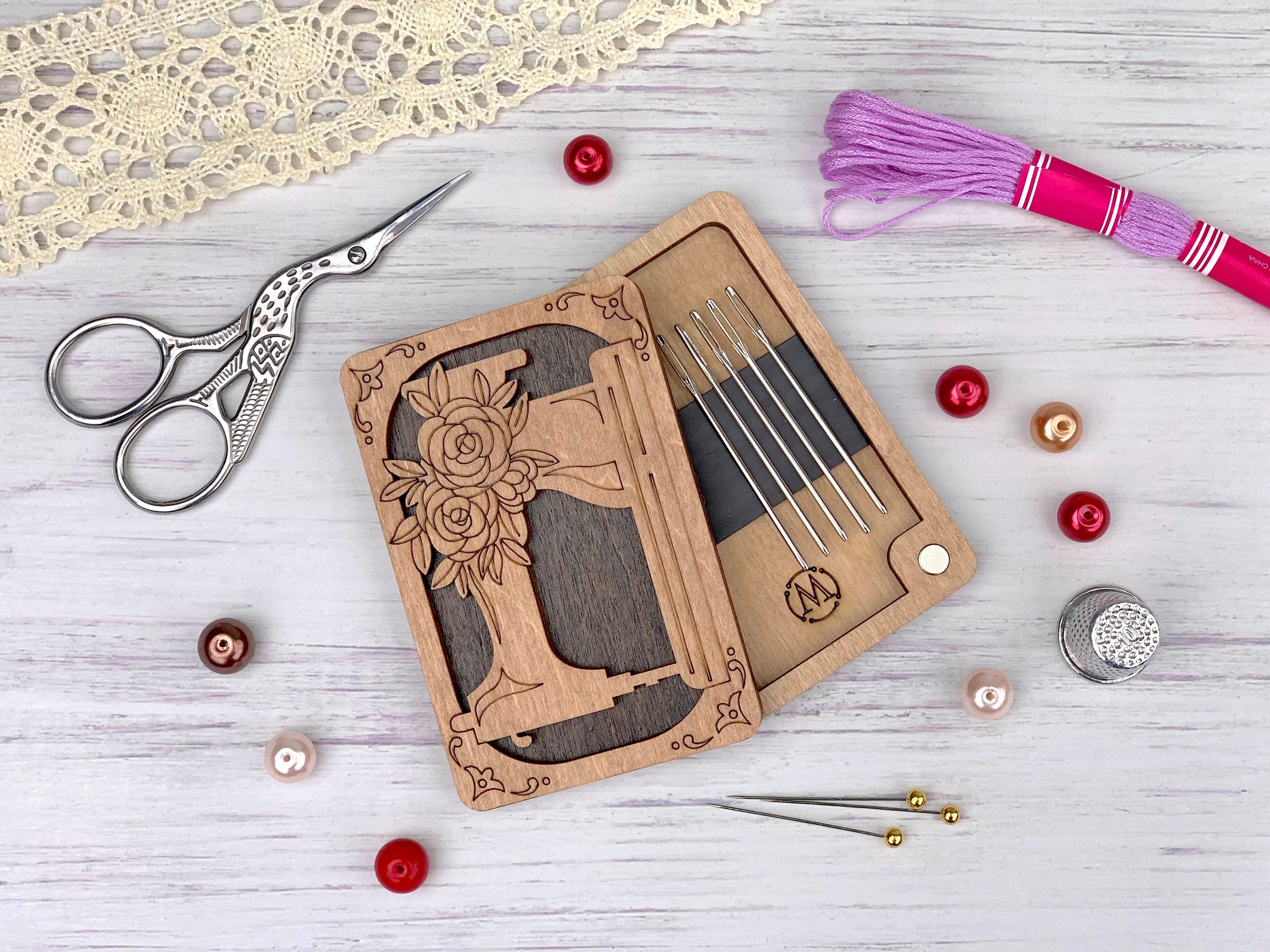 a pair of scissors, a pair of knitting needles, a pair of knitting needles