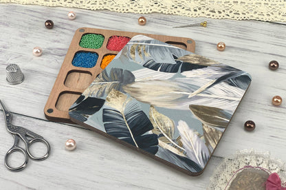 a wooden tray with paint and a pair of scissors