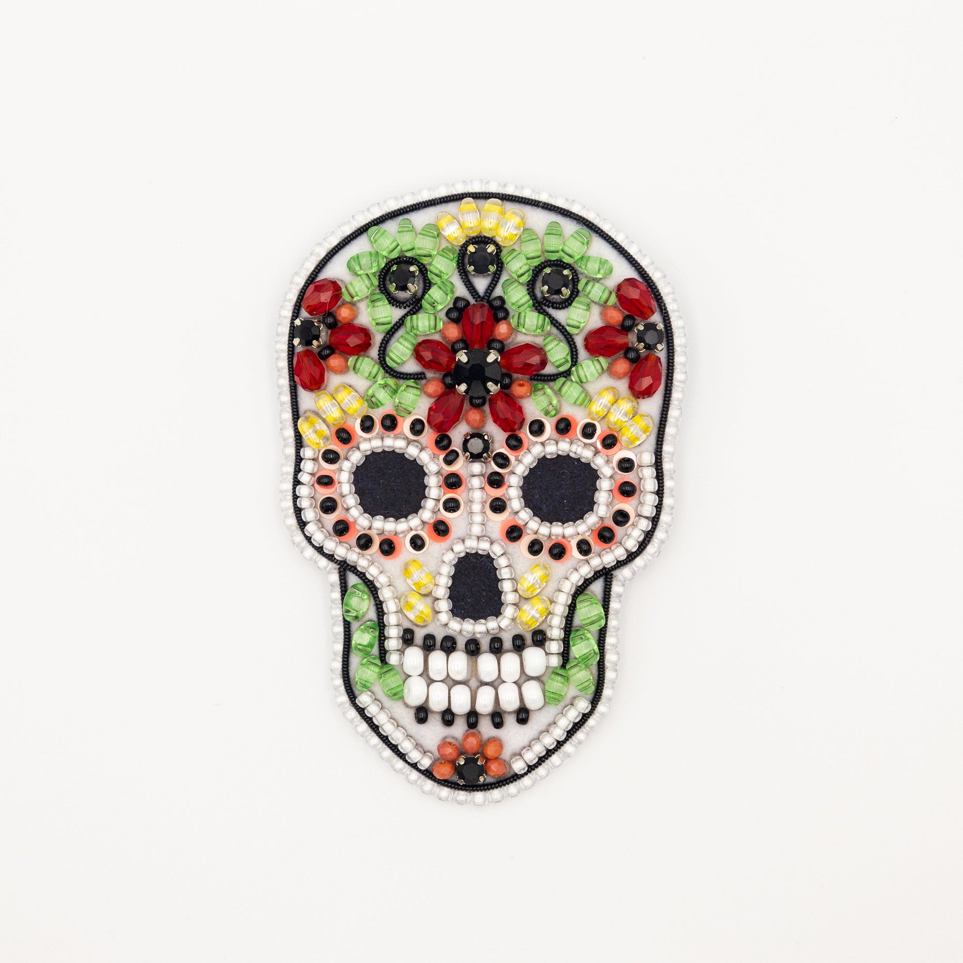 a beaded sugar skull on a white background