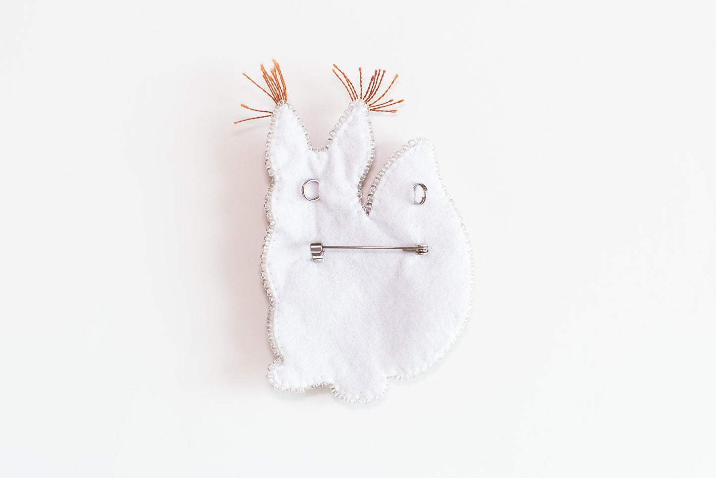 a piece of cloth with a hair pin in the shape of a rabbit