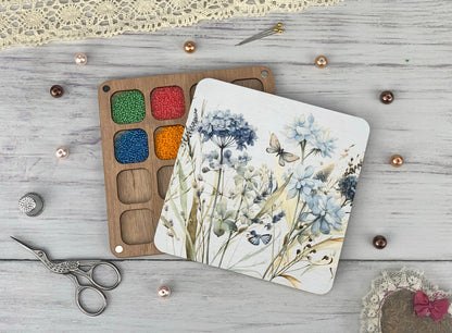 a pair of scissors and a paint palette on a table