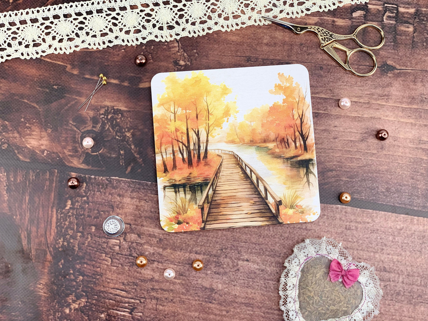 a card with a picture of a bridge on it next to a pair of scissors