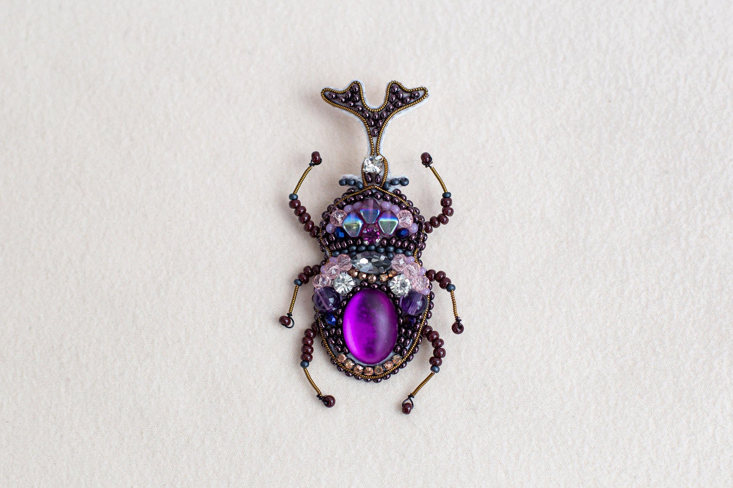 a close up of a bug on a white surface