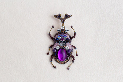 a close up of a bug on a white surface