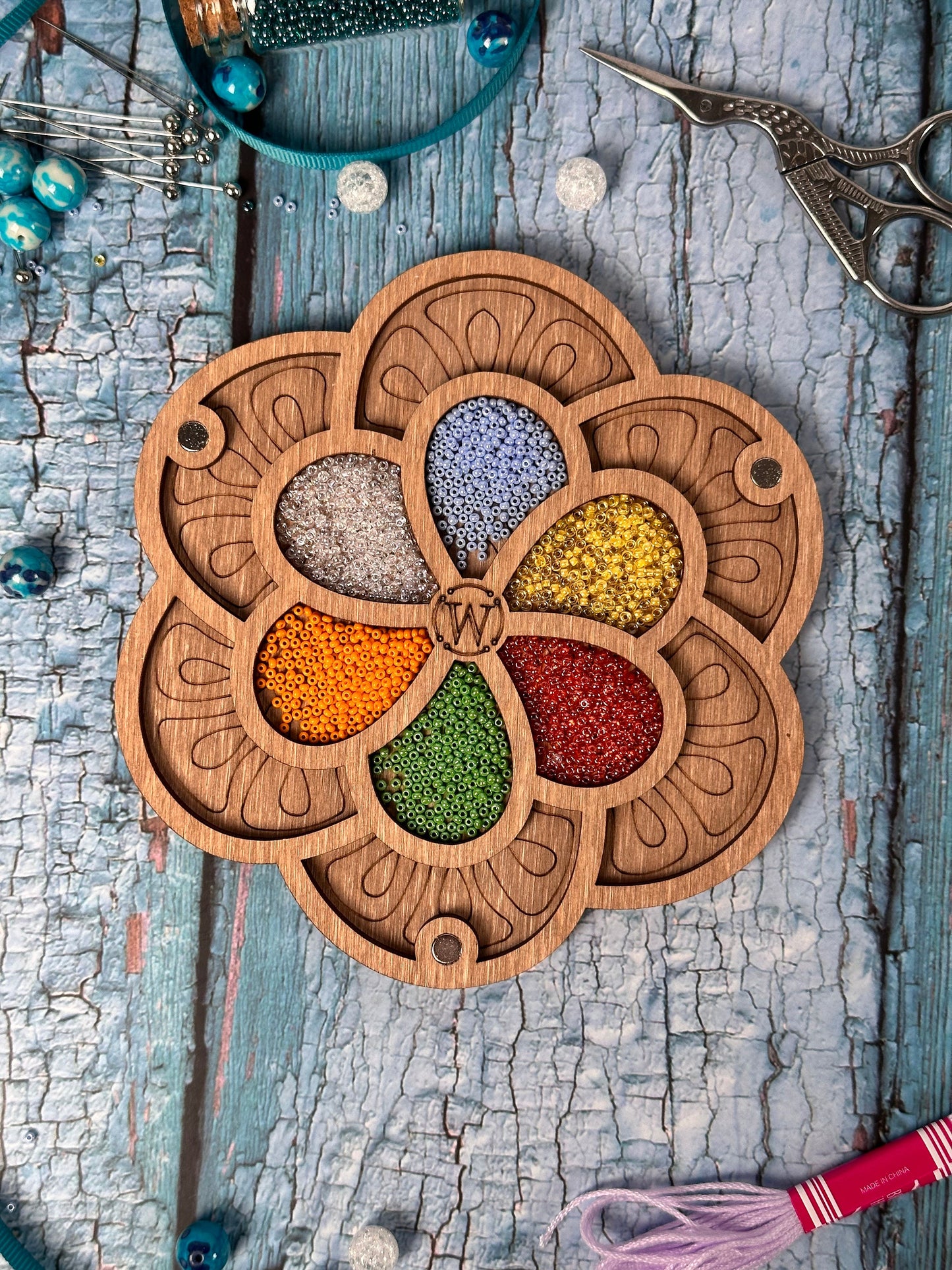 a wooden plate with a bunch of beads in it