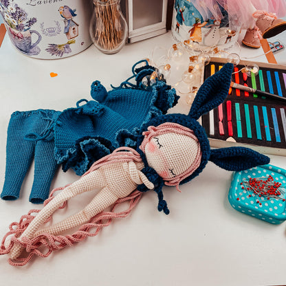 a doll laying on top of a table next to other items