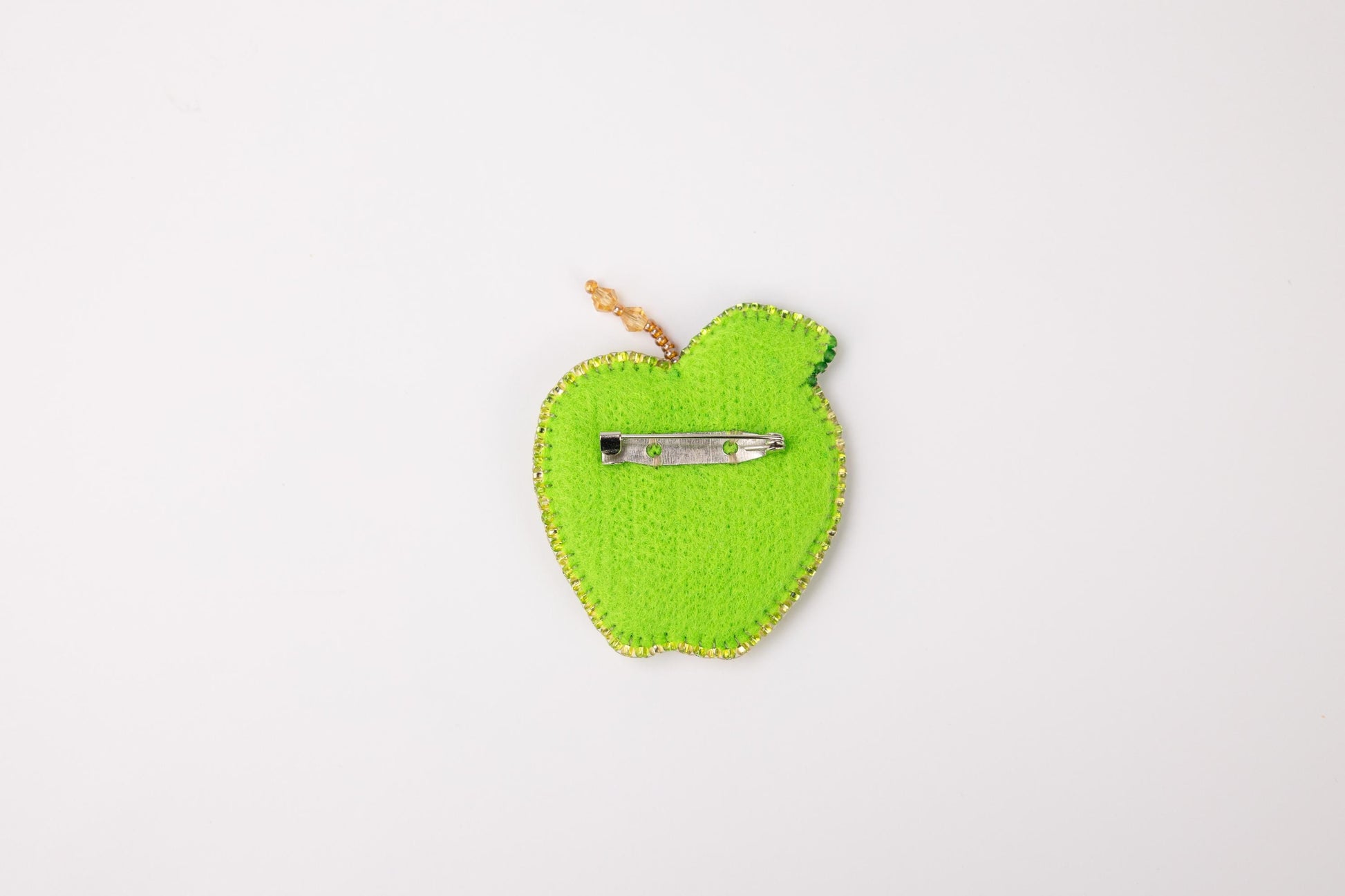 a green apple with a pair of scissors in it