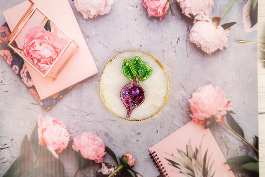 a table topped with pink flowers and a plate of food