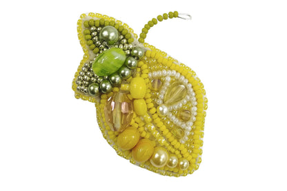 a close up of a beaded brooch on a white background