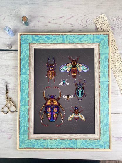a framed artwork depicting a collection of colorful, detailed insects, including a large dragonfly, a bee, and several other insects, all set against a dark background.