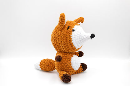 a crocheted stuffed animal sitting on a white surface