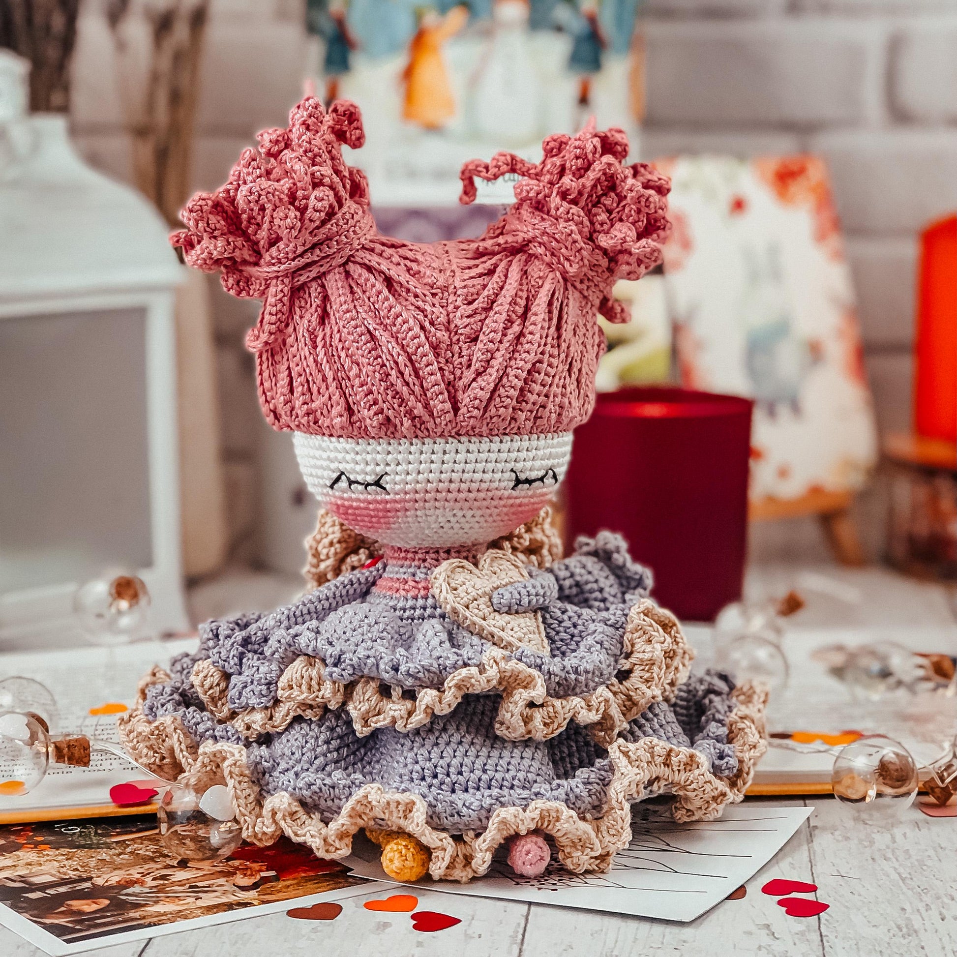 a crocheted doll sitting on top of a table