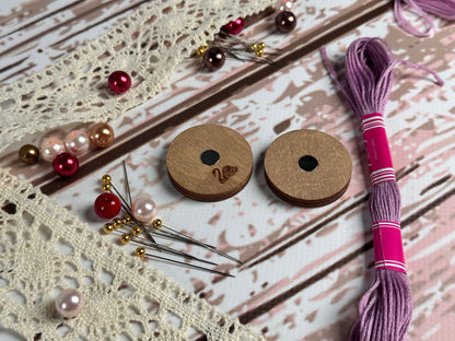 a pair of wooden buttons sitting on top of a table
