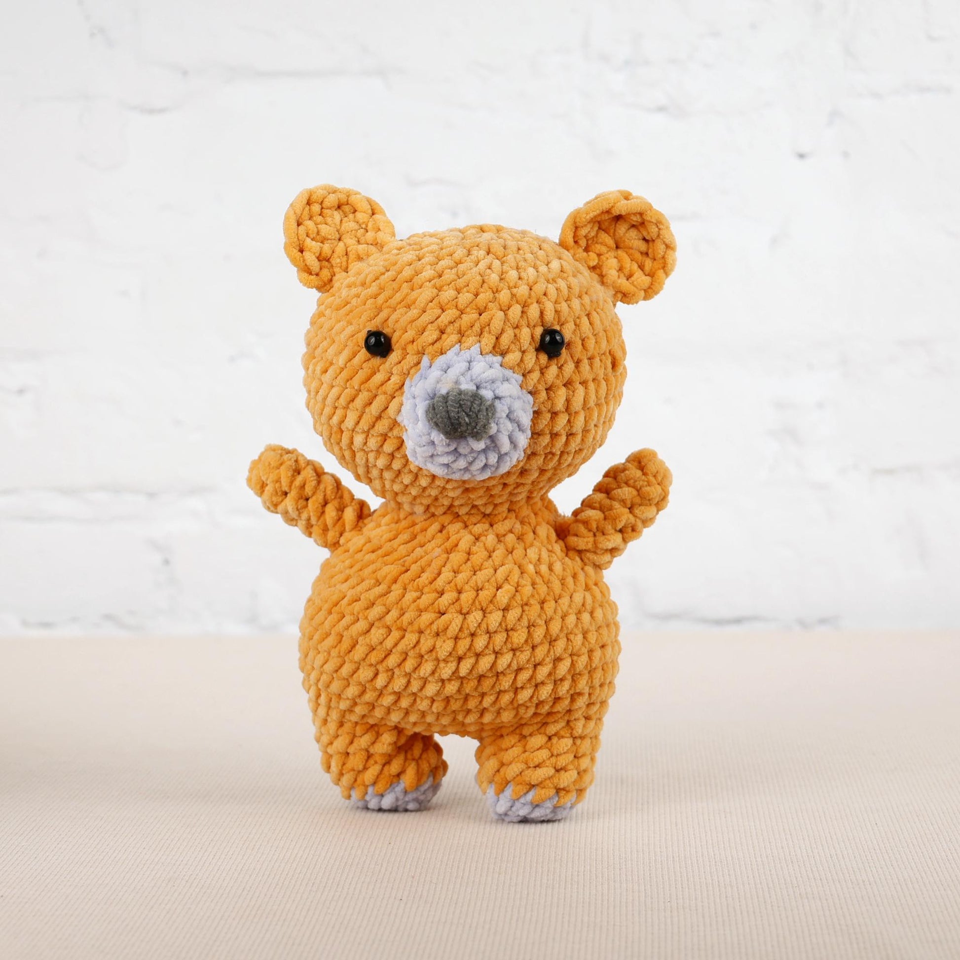 a teddy bear made out of yarn on a table