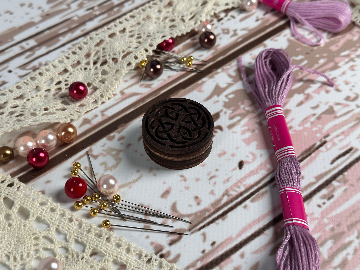 a pair of scissors and some beads on a table